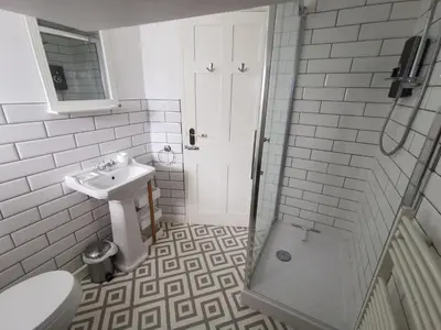 a bathroom with a sink and a toilet and a shower at Eldon Row - Stylish Character Apartments - Central Location 1 & 2 bed available in Dolgellau