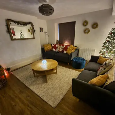 a living room with a christmas tree and a couch at Eldon Row - Stylish Character Apartments - Central Location 1 & 2 bed available in Dolgellau