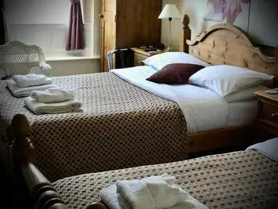 a bedroom with two beds with towels on them at The White Horse Inn, Clun in Clun