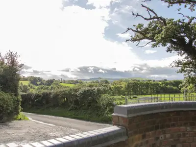 a brick wall next to a road at Black Lion Barn Retreat in Shrewsbury