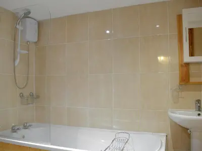 a bathroom with a bath tub and a sink at Paramount Cottage in Farden