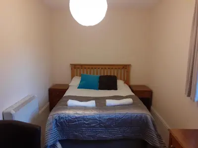 a bedroom with a bed with two pillows at Bryncarnedd Farmhouse in Aberystwyth