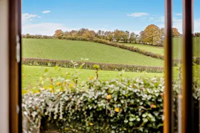 a view of a field from a train window at Gwilym's Stable in Builth Wells