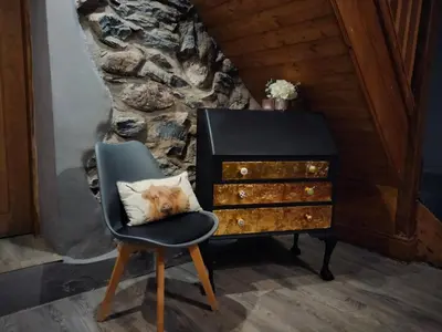a chair next to a dresser with a pillow on it at Cosy Minffordd Let - Llanuwchllyn near, Bala LL23 in Bala