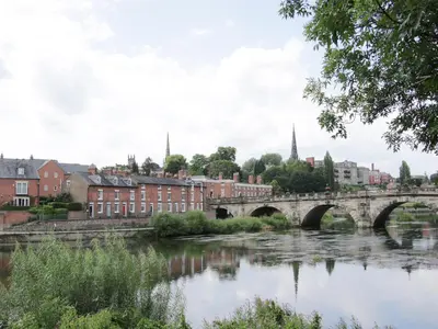 a bridge over a river in a city at Bank House Barn in Shrewsbury