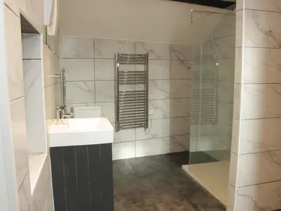 a bathroom with a sink and a glass shower at Bank House Barn in Shrewsbury