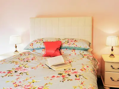 a bed with two pillows and a book on it at Holly Barn in Selattyn