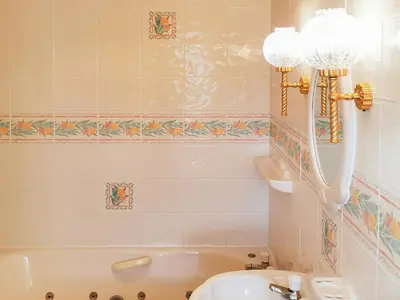 a bathroom with a sink and a bath tub at Holly Barn in Selattyn