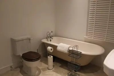 a bathroom with a tub and a toilet and a sink at Luxury townhouse in town centre, views, river walk, Free Parking in Shrewsbury