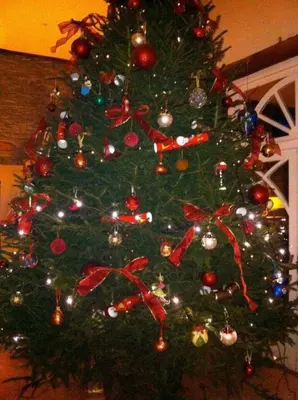 a christmas tree decorated with ornaments and bows at The Hillis Farmhouse - 6 Bed - Sleeps 11 - Pets in Brecon