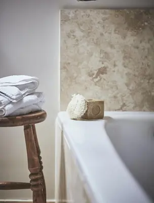 a bathroom with a bath tub with a towel at Tan Llan in Dolgellau