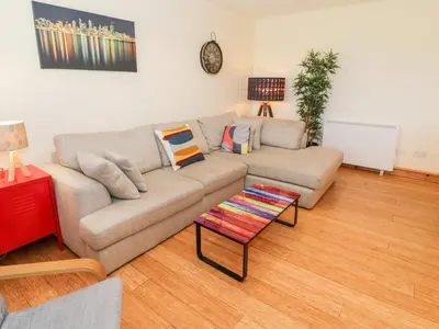 a living room with a couch and a table at Redwood in Harlech
