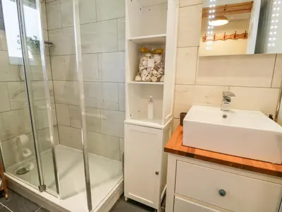 a bathroom with a sink and a shower at Redwood in Harlech