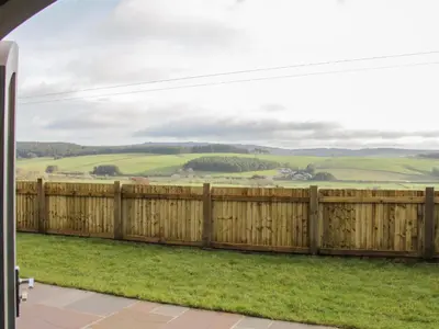 a fence with a view of the rolling hills at Stapeley Pod in Shrewsbury