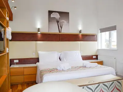 a bedroom with a bed with two white pillows at Plas Bach in Llanon