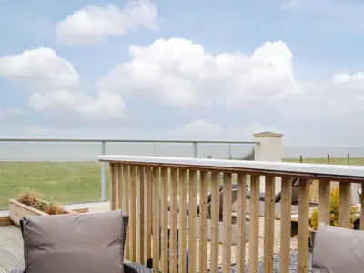 a balcony with a view of the ocean at Plas Bach in Llanon