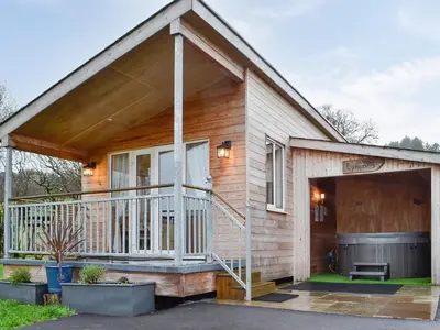 a small house with a porch and a garage at Tyncoed - Uk32238 in Lower Chapel
