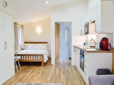 a small kitchen with a bed in a room at Tyncoed - Uk32238 in Lower Chapel