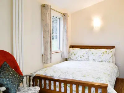 a small bedroom with a bed and a window at Tyncoed - Uk32238 in Lower Chapel