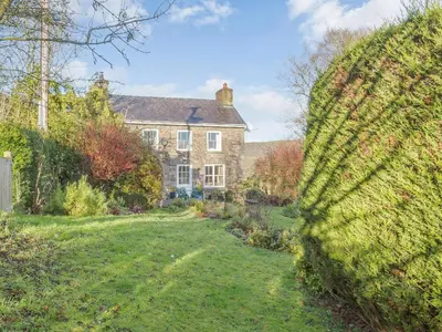 a large brick house with a grass yard at Pen Y Crug in Beulah