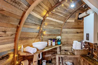 a bathroom with a wooden ceiling and a sink at HOBLEY House Holiday in Craven Arms