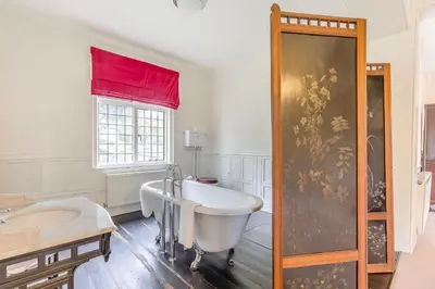 a large bathroom with a tub and a sink at The Generals Quarters at Pitchford Estate in Shrewsbury