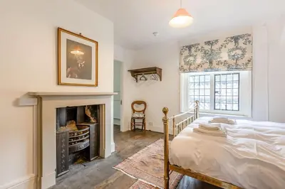 a bedroom with a bed and a fireplace at The Generals Quarters at Pitchford Estate in Shrewsbury