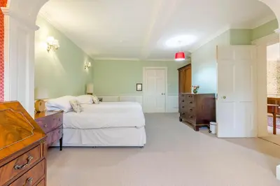 a large bedroom with a bed and a dresser at The Generals Quarters at Pitchford Estate in Shrewsbury