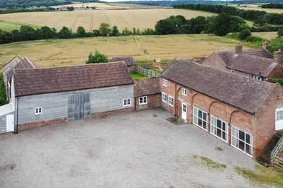 an aerial view of a barn with a large driveway at Stockbatch Granary at Pitchford Estate in Shrewsbury