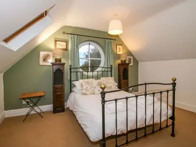 a bedroom with a bed and a window at Windy Mundy Farm at Pitchford Estate in Shrewsbury