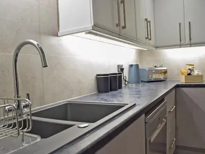 a kitchen with a sink and a counter top at Bristol House in New Quay