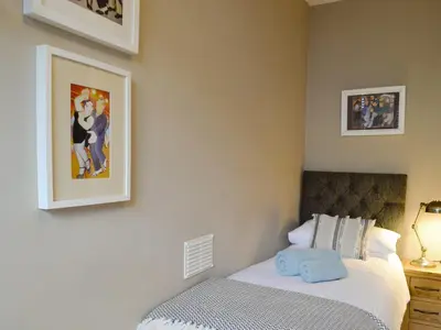 a bedroom with a bed and two pictures on the wall at The Apartment in Brecon