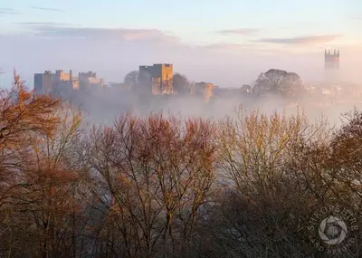 a city in the fog with trees and buildings at Wisteria Cottages are self catering cottages in a beautiful village location in Dorrington