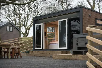a tiny house with a large sliding glass door at The Fox Den in Rhayader