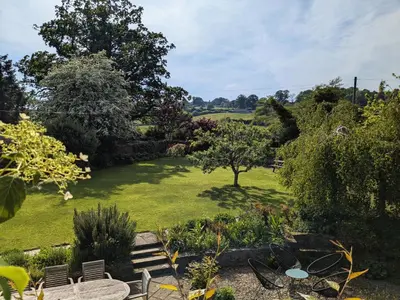 a garden with a green lawn and a tree at Little Underhill in Oswestry
