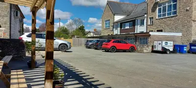 a row of cars parked in a parking lot at Greyhound Hotel in Wales