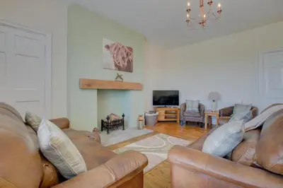a living room with two leather couches and a fireplace at 3 Bed in Welshpool oc-bow122 in Welshpool