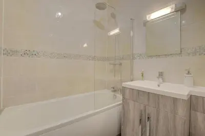 a bathroom with a tub and a sink and a bath tub at 3 Bed in Welshpool oc-bow122 in Welshpool