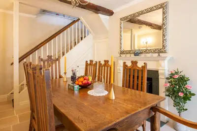 a dining room with a wooden table and a mirror at Turford House, Ludlow in Ludlow