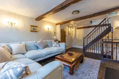a living room with a couch and a table at Turford House, Ludlow in Ludlow