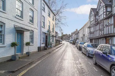 a city street with cars parked on the side of the road at Turford House, Ludlow in Ludlow