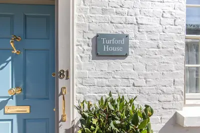 a blue door of a house with a sign that reads fluid house at Turford House, Ludlow in Ludlow