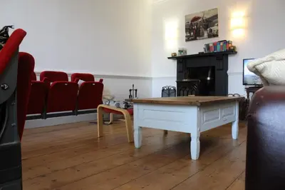 a living room with a coffee table and red chairs at 4BedHouse Leominster Hiking Castles Sleeps7 Wifi in Leominster