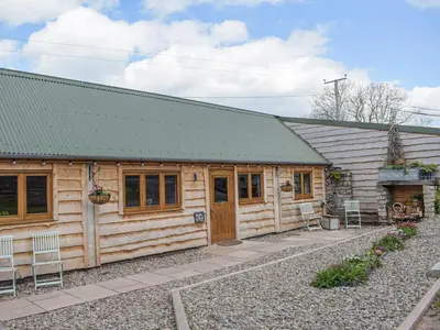 a wooden cabin with a green roof at Gooses Roost - Uk32096 in Dorstone