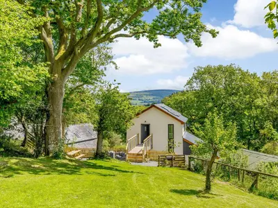 a house in the middle of a yard at Barn Owls Rest in Clyro