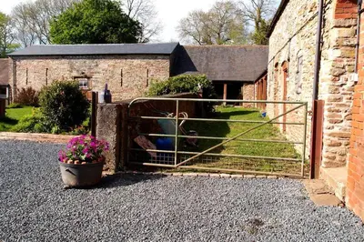 a gate to a barn with a teddy bear in it at Upper Heath Farm - Stable Cottage Ludlow in Craven Arms