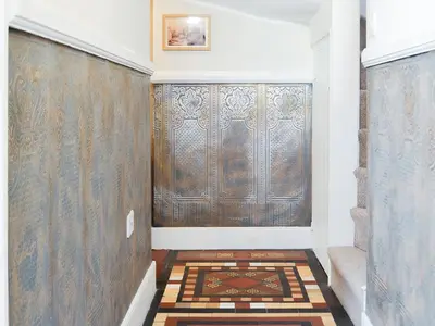 a hallway with a large window and a rug at The Mill House, The Square in Talgarth
