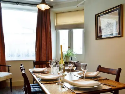 a dining room table with glasses and napkins on it at The Mill House, The Square in Talgarth