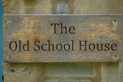 a sign on the side of a old school house at The old school house in Burwarton
