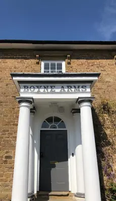 a front door of a building with a sign on it at The old school house in Burwarton